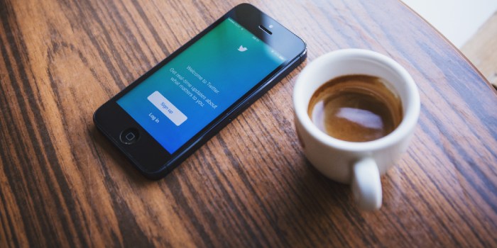 tazzina di caffè con app di twitter aperta sul cellulare
